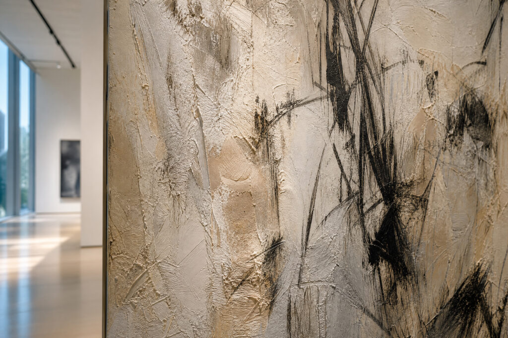 Close-up of the textured surface of a Petrichor Painting by Shellie Garber style work in a high-end gallery.