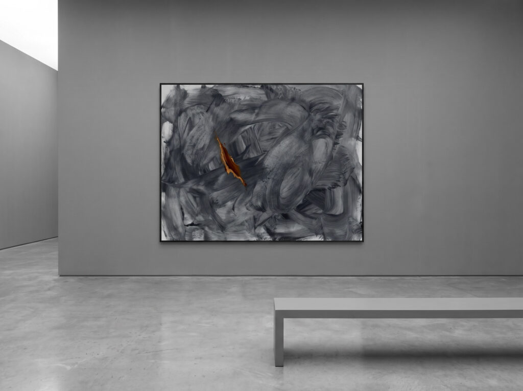 The strategic accent in Minimalist Color Psychology: A monochromatic space with a single orange-accented painting.